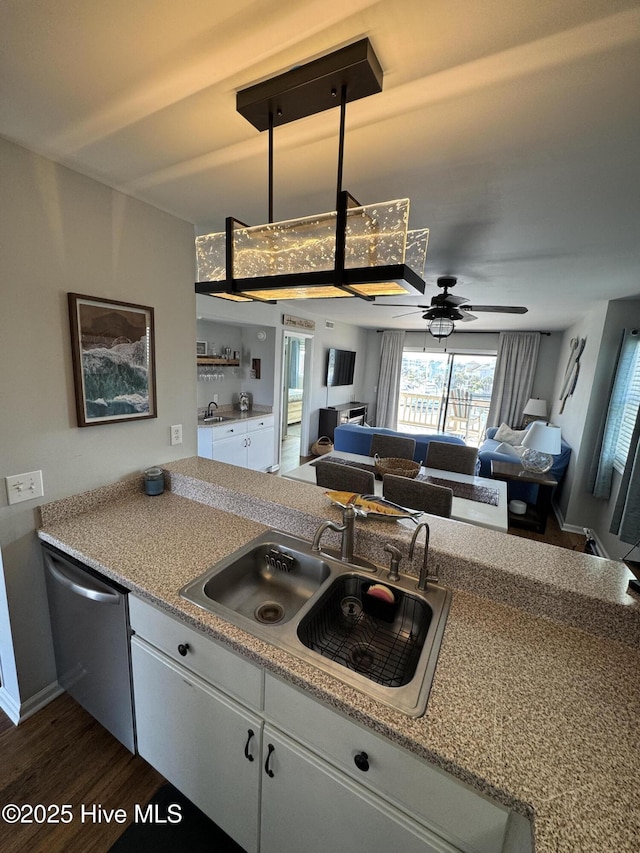 kitchen with dishwasher, a sink, a ceiling fan, dark wood-style floors, and open floor plan
