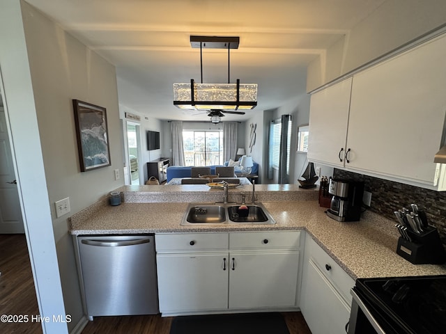 kitchen with a sink, dishwasher, white cabinets, dark wood finished floors, and open floor plan