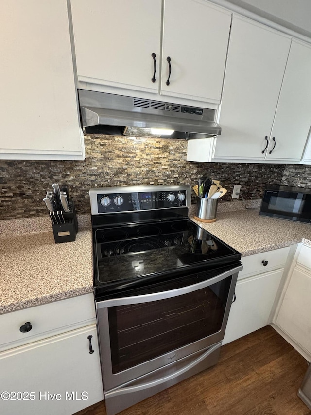kitchen featuring stainless steel range with electric stovetop, under cabinet range hood, black microwave, white cabinets, and tasteful backsplash