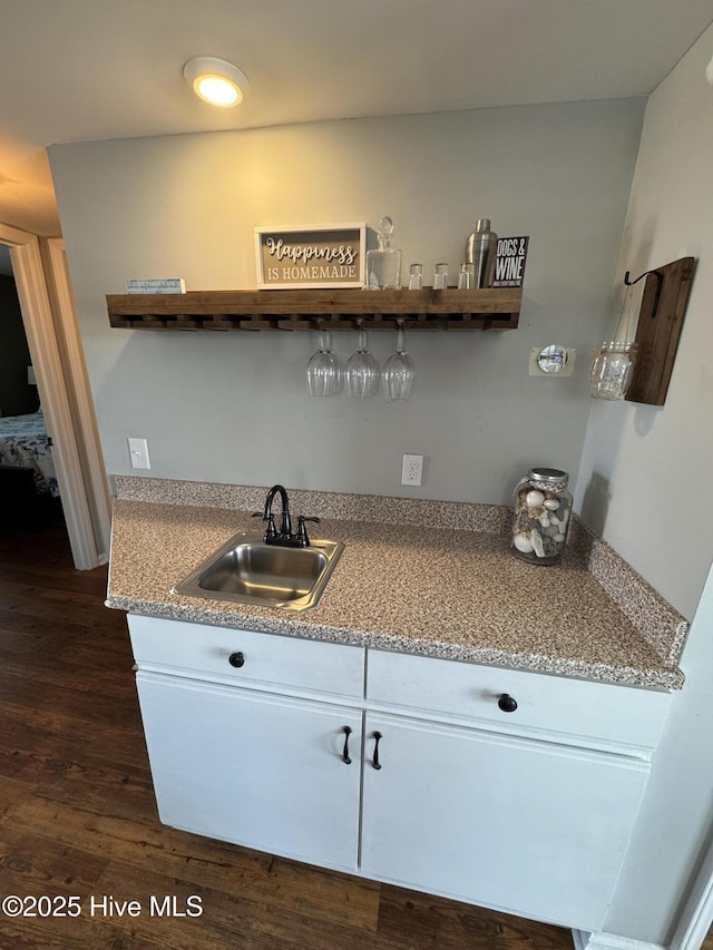 kitchen with open shelves, a sink, dark wood-type flooring, and white cabinetry