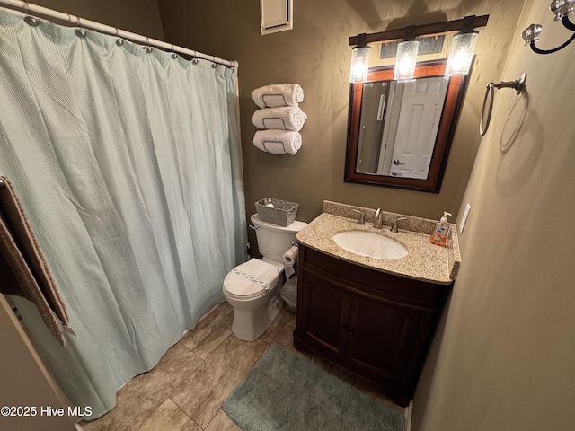 bathroom featuring toilet, vanity, a shower with shower curtain, and tile patterned flooring