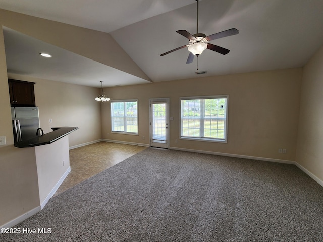 108 Hill Farm Dr, Richlands, NC 28574 - unfurnished living room featuring a chandelier, baseboards, vaulted ceiling, ceiling fan, and carpet floors