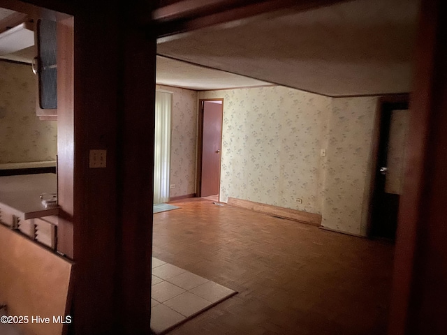 basement featuring wallpapered walls