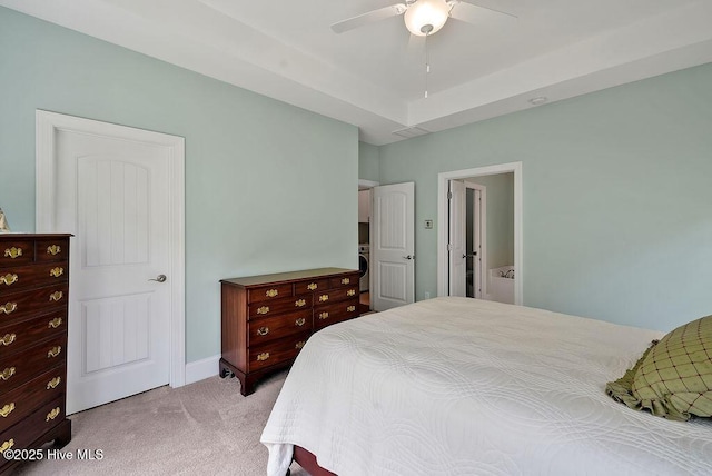 carpeted bedroom with washer / clothes dryer, ceiling fan, and baseboards
