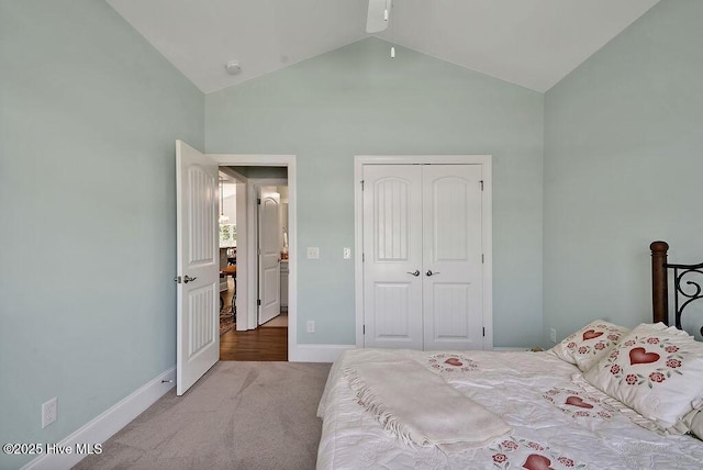 bedroom featuring carpet flooring, baseboards, a closet, and high vaulted ceiling