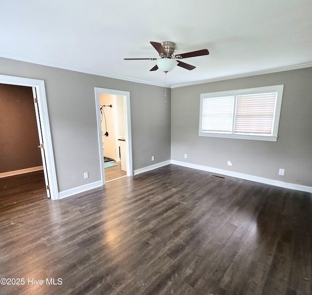 1120 Princeton Kenly Rd, Kenly, NC 27542 - unfurnished bedroom featuring a spacious closet, ornamental molding, dark wood-type flooring, baseboards, and a closet