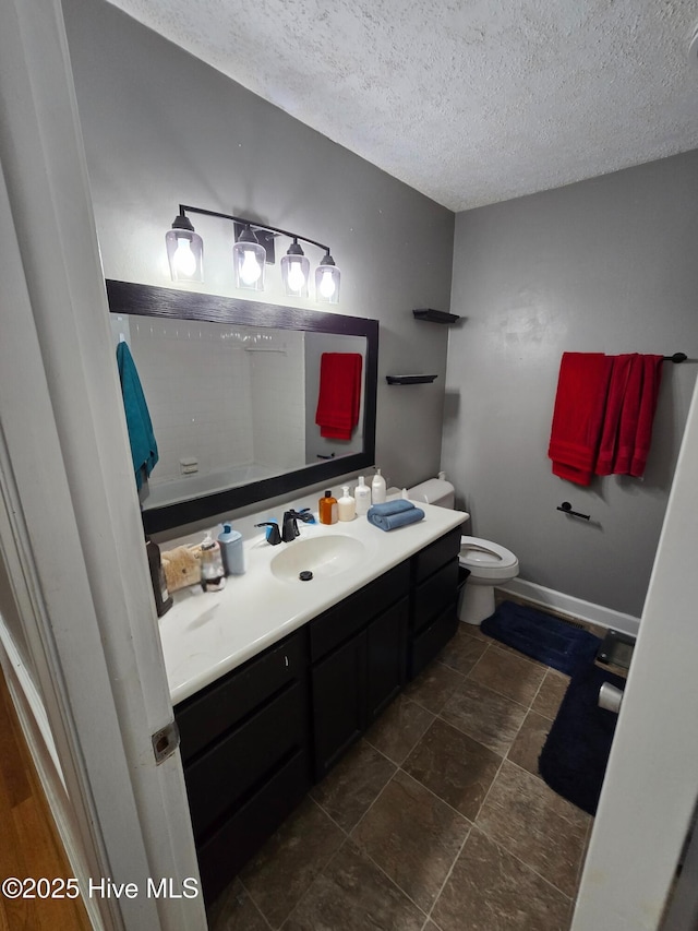 1120 Princeton Kenly Rd, Kenly, NC 27542 - bathroom with vanity, a textured ceiling, toilet, and stone finish flooring