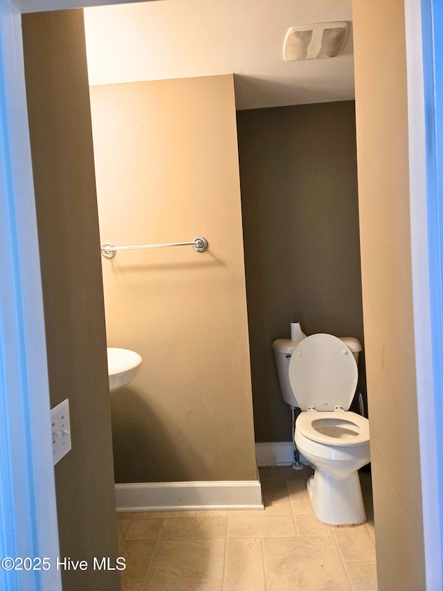 1120 Princeton Kenly Rd, Kenly, NC 27542 - bathroom with toilet, baseboards, and tile patterned floors