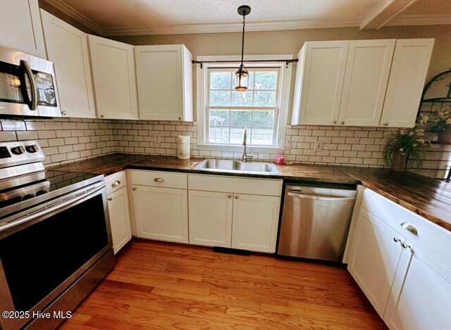 1120 Princeton Kenly Rd, Kenly, NC 27542 - dining room featuring light wood-style flooring, ornamental molding, and beam ceiling