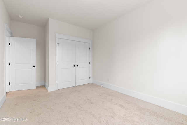 61 Tanglewood Ct, Hampstead, NC 28443 - unfurnished bedroom with light carpet, a closet, and baseboards