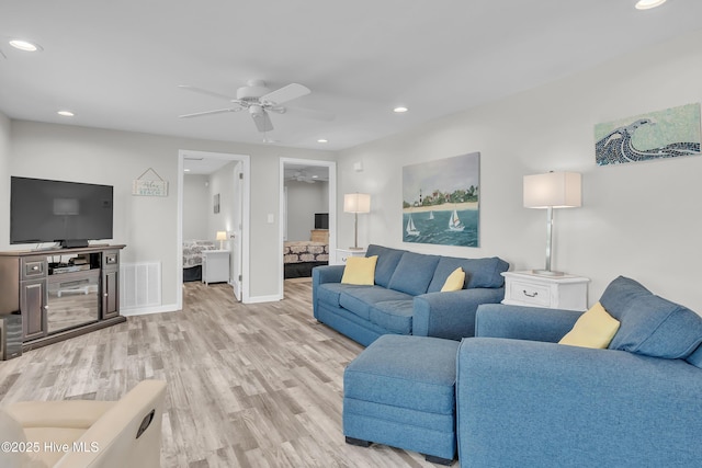 living area featuring a ceiling fan, light wood-type flooring, recessed lighting, and baseboards