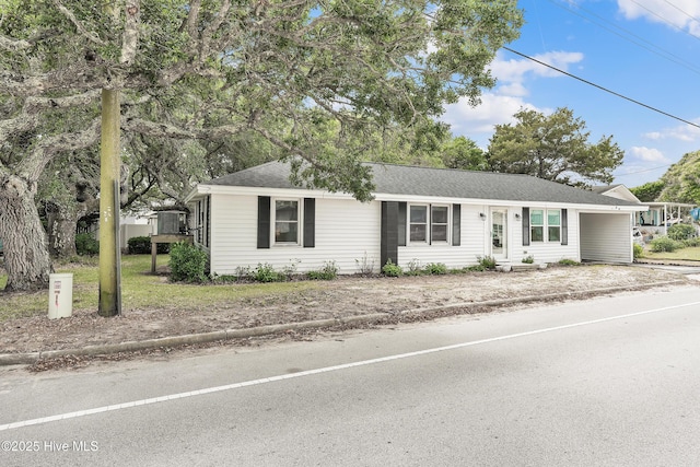 single story home with an attached carport and a shingled roof