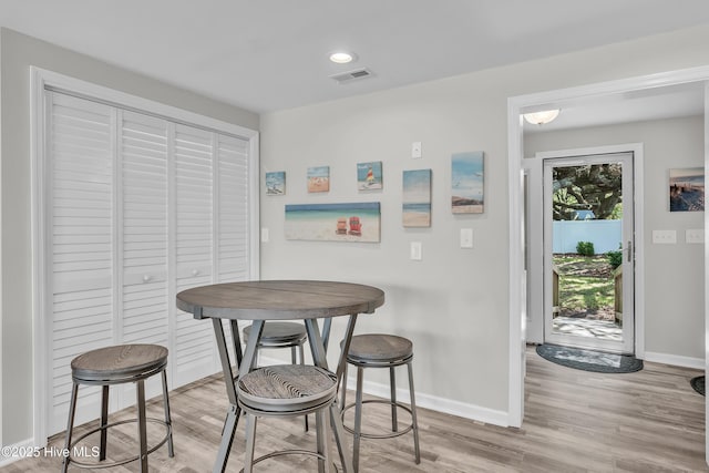 dining room featuring baseboards and light wood finished floors