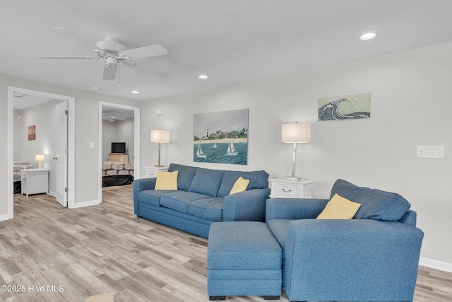 living room with a ceiling fan, light wood-type flooring, recessed lighting, and baseboards
