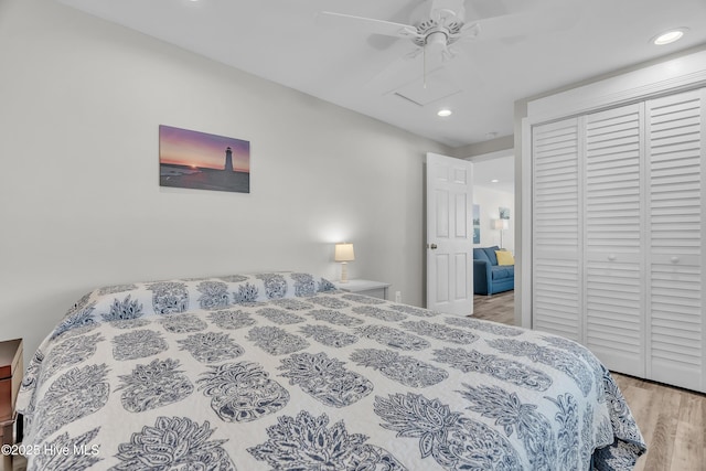 bedroom with wood finished floors, a closet, recessed lighting, and ceiling fan