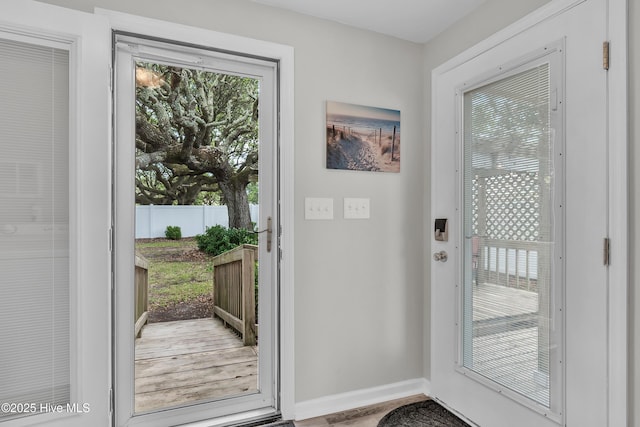 doorway to outside with baseboards