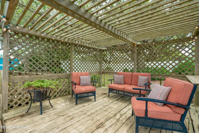 wooden deck featuring a pergola and an outdoor living space