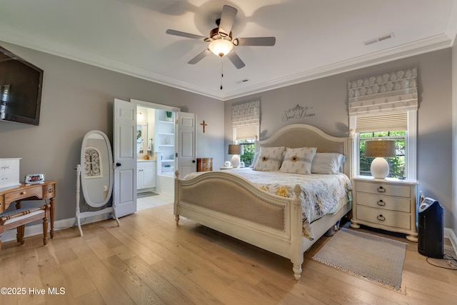 bedroom featuring crown molding, light wood-style floors, and visible vents