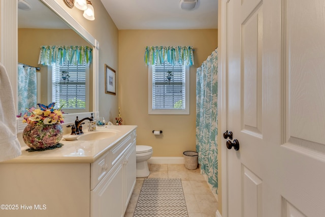 full bathroom with tile patterned floors, toilet, baseboards, and vanity