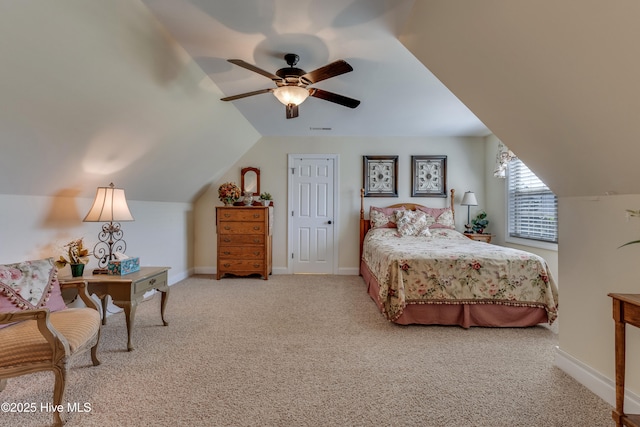 carpeted bedroom with baseboards, a ceiling fan, and vaulted ceiling