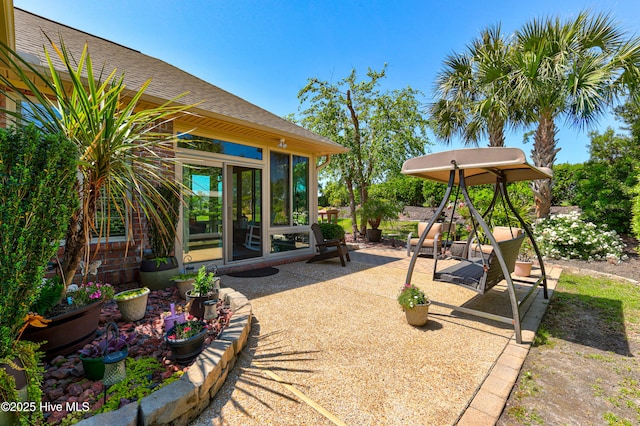 view of patio / terrace featuring a sunroom