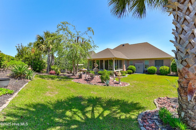 view of yard featuring a patio area and a sunroom