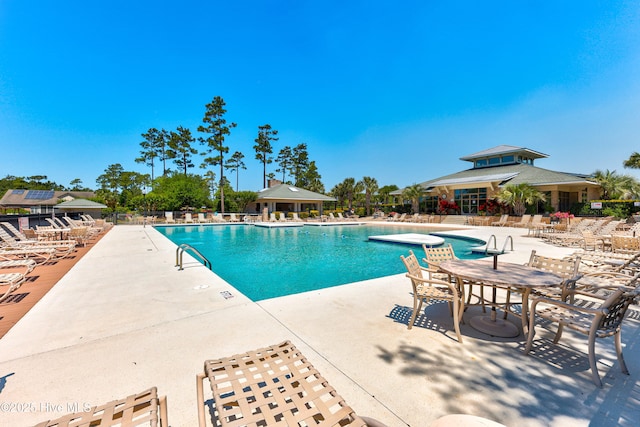 pool featuring a patio and fence