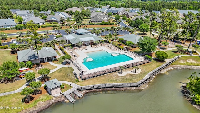 drone / aerial view with a water view and a residential view