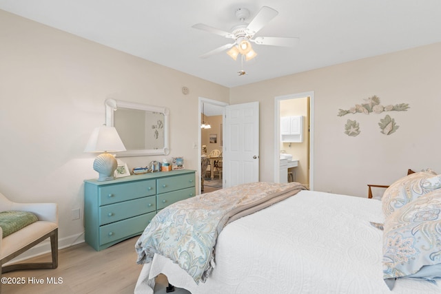 404 Sunset Oaks Ln, Sunset Beach, NC 28468 - bedroom featuring light wood-style flooring, baseboards, ensuite bathroom, and ceiling fan