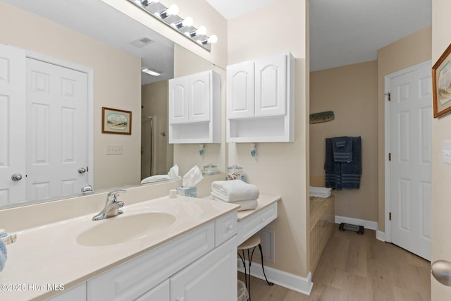 404 Sunset Oaks Ln, Sunset Beach, NC 28468 - full bathroom with wood finished floors, vanity, baseboards, and a shower