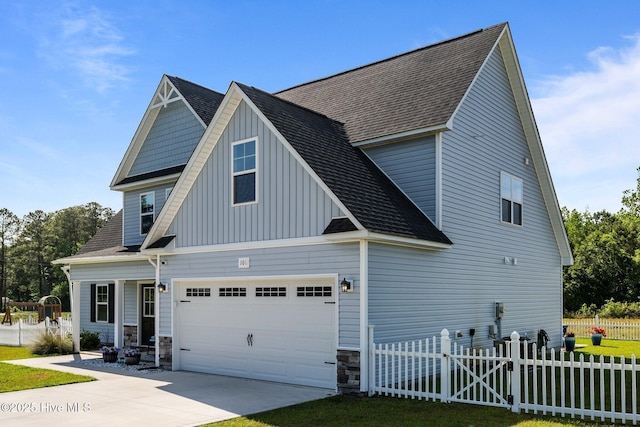 view of side of property with fence, driveway, a shingled roof, and board and batten siding