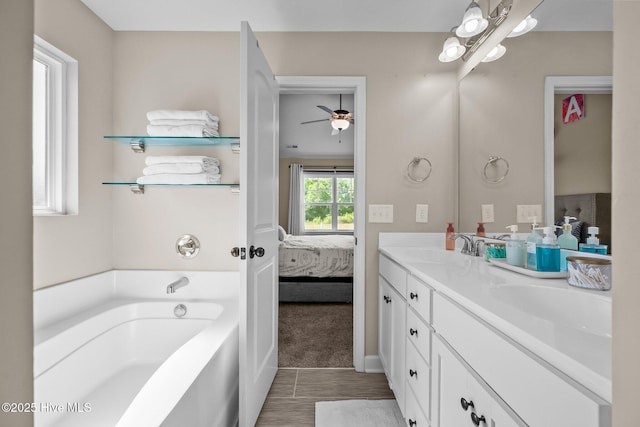 ensuite bathroom featuring a sink, double vanity, ensuite bathroom, and a bath