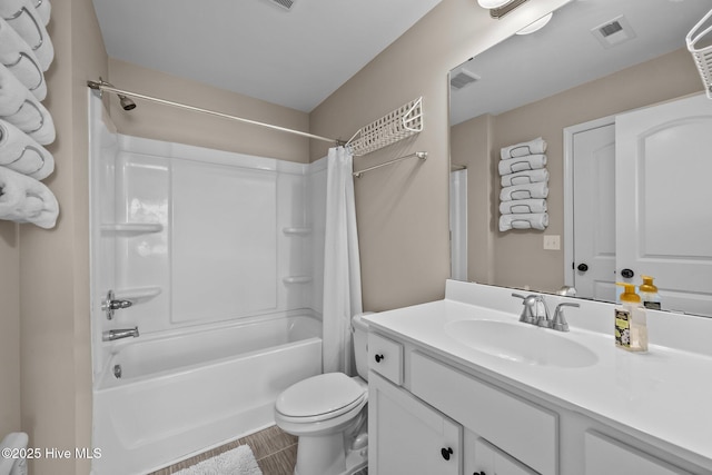 bathroom featuring toilet, vanity, visible vents, and shower / bath combination with curtain