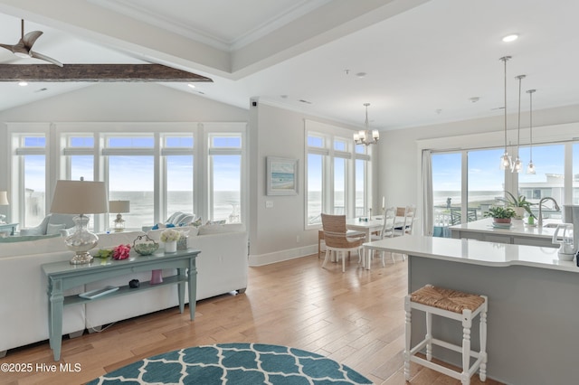 26 Seagull St Unit B, Wrightsville Beach, NC 28480 - living room featuring a chandelier, light wood finished floors, crown molding, a water view, and recessed lighting