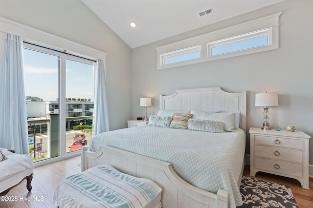 26 Seagull St Unit B, Wrightsville Beach, NC 28480 - bedroom with multiple windows, light wood-style floors, vaulted ceiling, access to outside, and recessed lighting