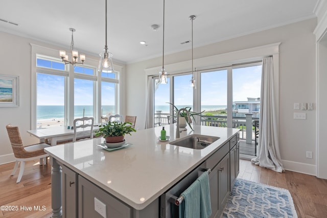 26 Seagull St Unit B, Wrightsville Beach, NC 28480 - kitchen featuring a sink, dishwasher, crown molding, a water view, and baseboards