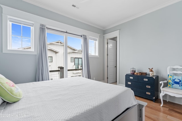 26 Seagull St Unit B, Wrightsville Beach, NC 28480 - bedroom featuring light wood-style floors and ornamental molding