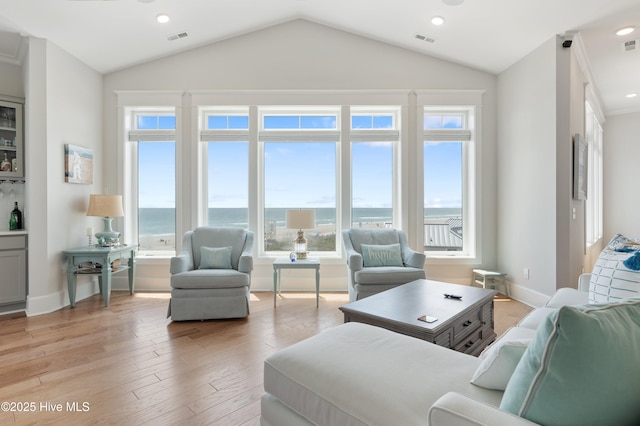 26 Seagull St Unit B, Wrightsville Beach, NC 28480 - living room featuring vaulted ceiling, light wood-style floors, recessed lighting, baseboards, and a water view