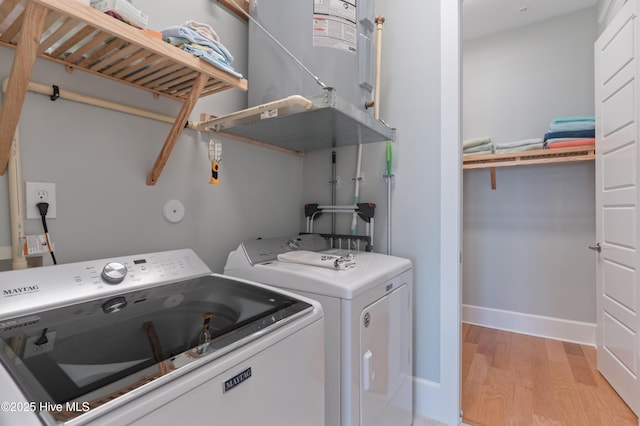 26 Seagull St Unit B, Wrightsville Beach, NC 28480 - laundry area featuring washer and clothes dryer, light wood finished floors, and baseboards
