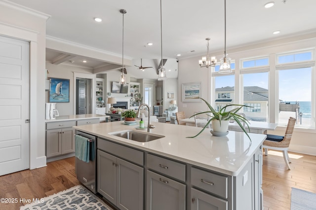 26 Seagull St Unit B, Wrightsville Beach, NC 28480 - kitchen with gray cabinetry, a sink, stainless steel dishwasher, a fireplace, and crown molding