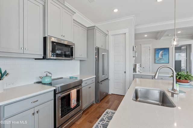 26 Seagull St Unit B, Wrightsville Beach, NC 28480 - kitchen featuring appliances with stainless steel finishes, a sink, light countertops, wood finished floors, and recessed lighting