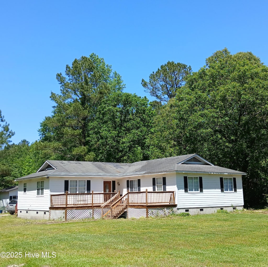 view of front facade with crawl space, a wooden deck, a front lawn, and roof with shingles