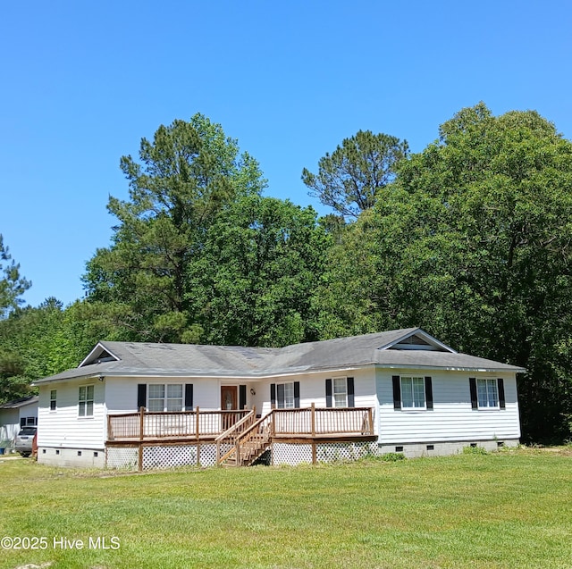 view of front facade with crawl space, a wooden deck, a front lawn, and roof with shingles