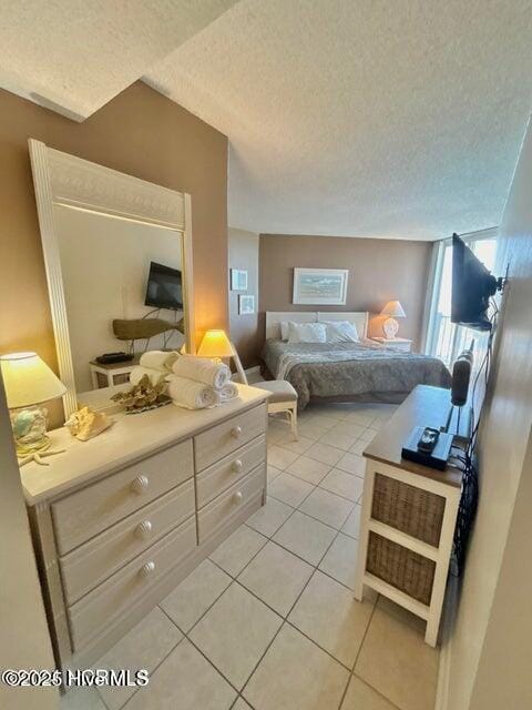 bedroom with light tile patterned floors and a textured ceiling
