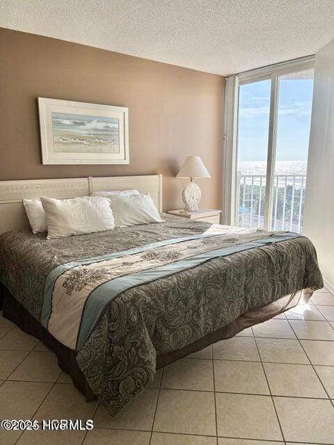 bedroom with a textured ceiling and light tile patterned flooring