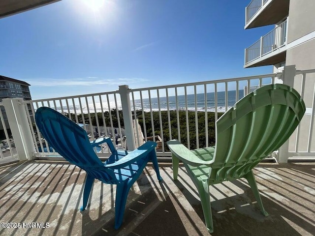 balcony with view of water and beach