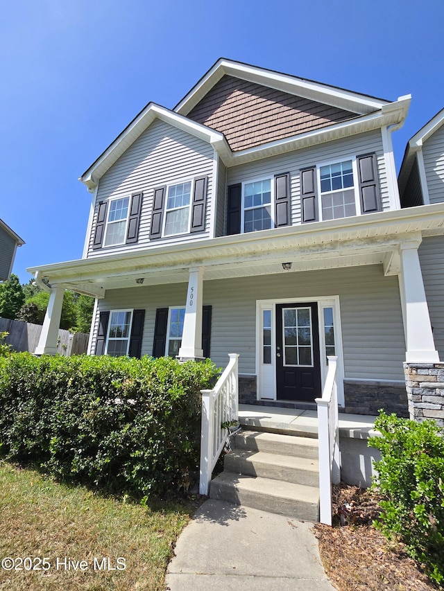 view of front of property featuring a porch and stone siding