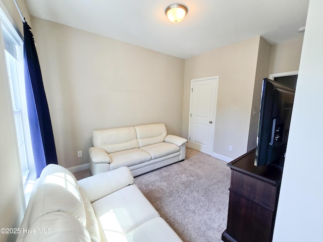 living area featuring carpet and baseboards