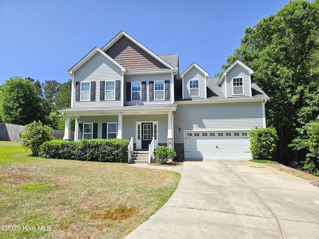 craftsman house featuring concrete driveway, a front yard, a porch, and fence