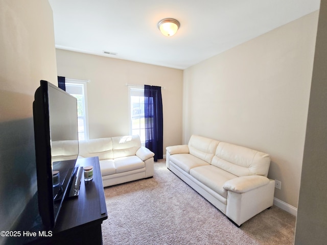 living room featuring baseboards, visible vents, and carpet